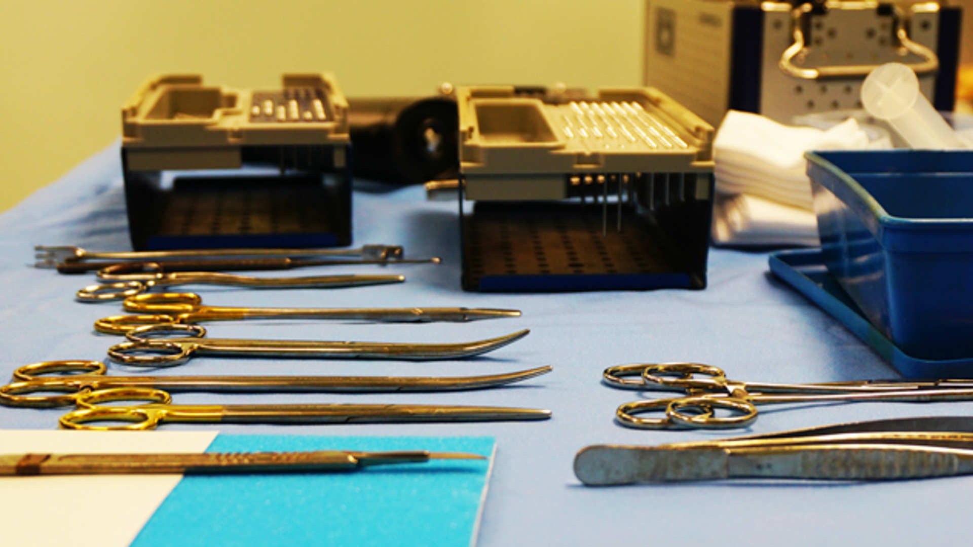Surgical instruments are laid out in neat rows on a trolley ready for the next procedure