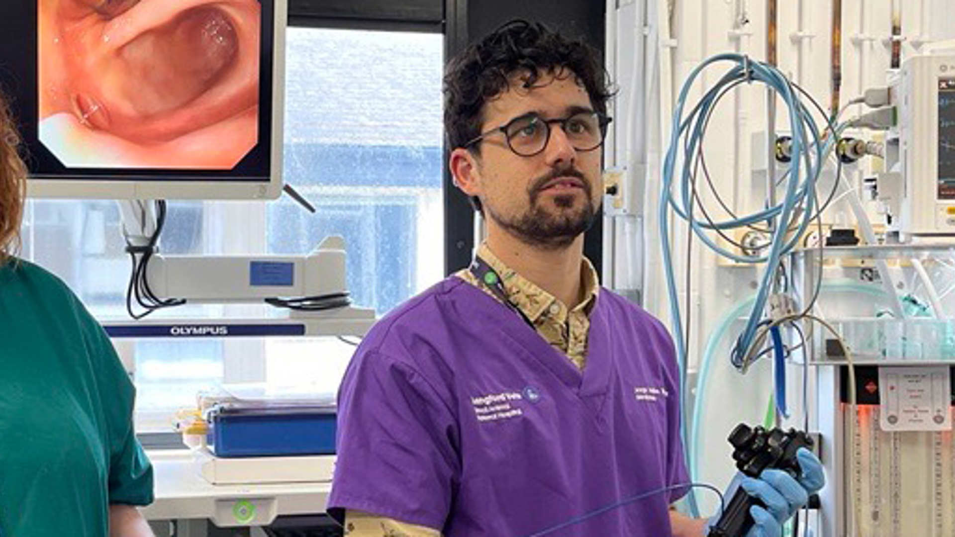 A vet performs endoscopy while the team watch the results on a screen